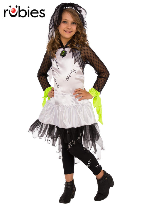 Monster Bride child costume with white and black dress, green wrist ties, scar-print tights and spiked veil headband