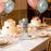 Silver disco mirror number 8 freestanding on birthday party table with balloons and cake