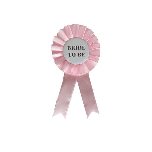 Bride To Be pink satin ribbon rosette badge on white background