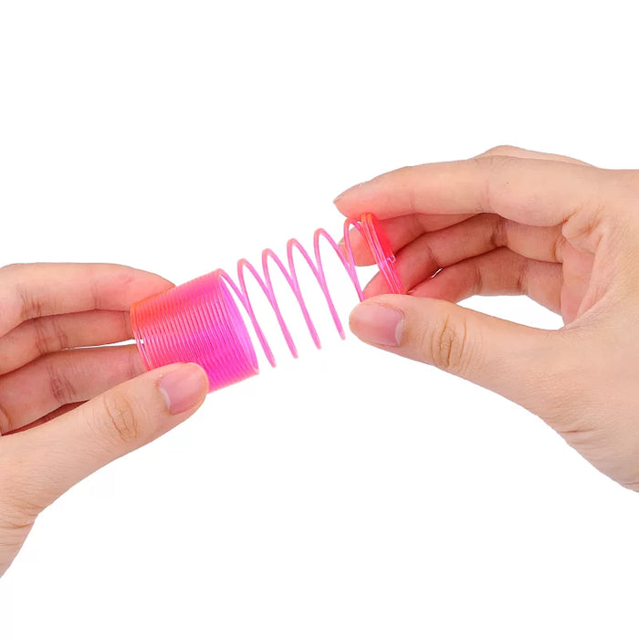 Hands stretching a pink neon rainbow spring toy