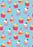 Light blue folded gift wrap featuring smiling cupcakes in pink, purple and orange cases