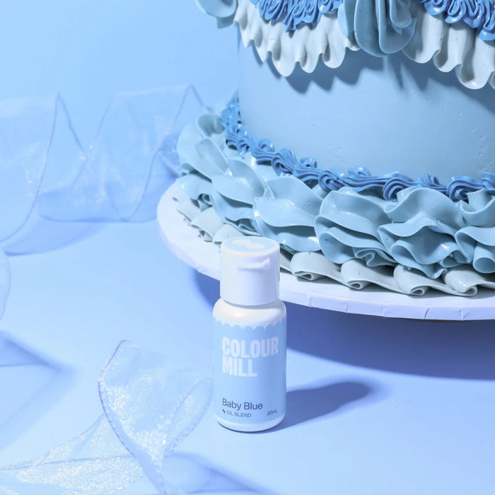 Colour Mill Baby Blue Oil Blend 20ml bottle beside pastel blue buttercream cake ruffles