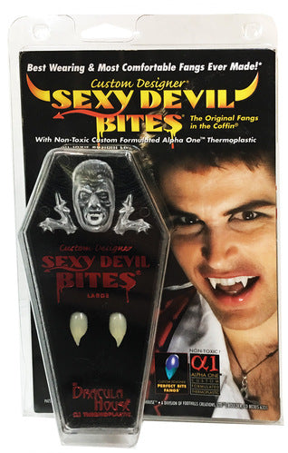 Sexy Devil Bites fangs in coffin packaging inside a blister pack, with a photograph of a man wearing fangs.