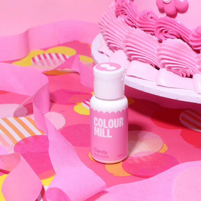 Colour Mill Candy Oil Blend bottle beside a pink buttercream cake