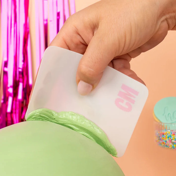 Colour Mill Flexi Scraper smoothing green icing on a cake