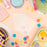Colour Mill Flexi Scraper 2-pack displayed with decorated cakes and cookies