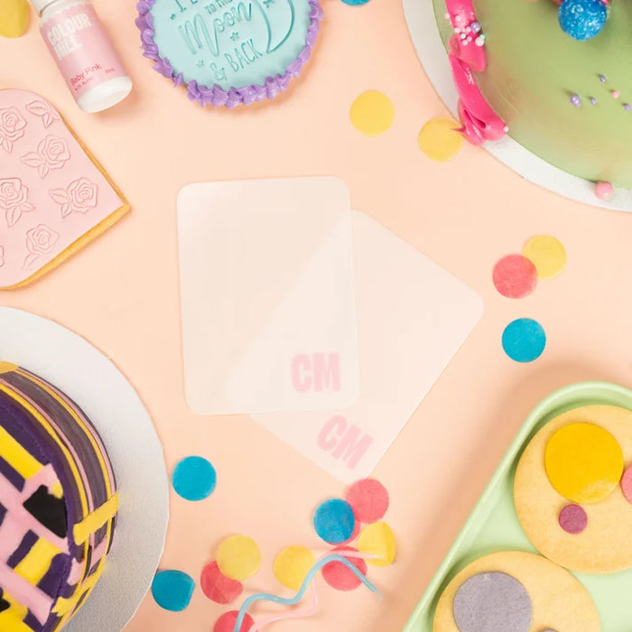 Colour Mill Flexi Scraper 2-pack displayed with decorated cakes and cookies
