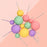 Pastel Bloom matte ball cake toppers in mint green, pink, purple and yellow on wires