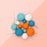 Ocean Breeze matte ball cake toppers in teal, blue, orange and white on wires