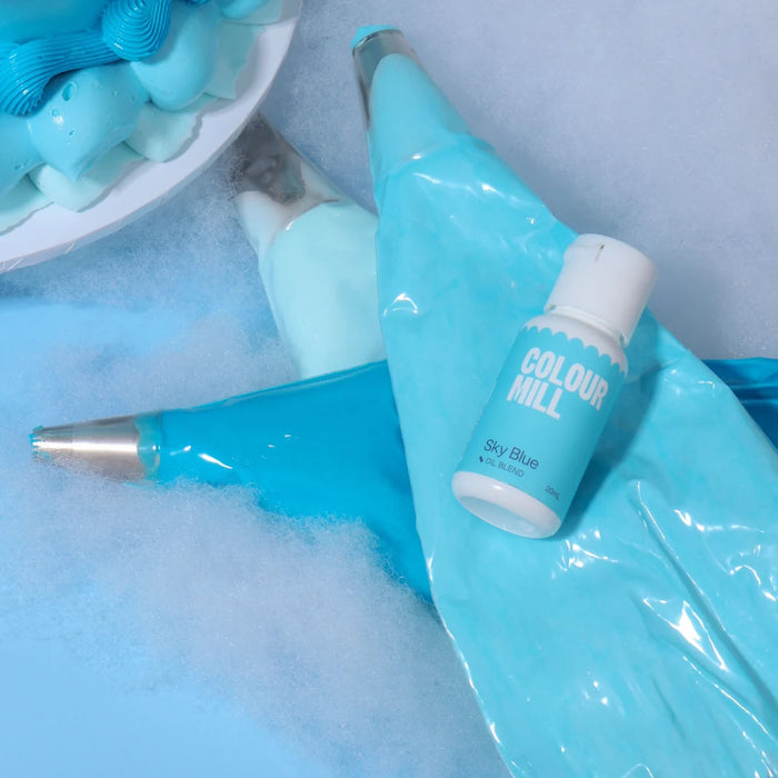 Colour Mill Sky Blue bottle resting on blue icing piping bags