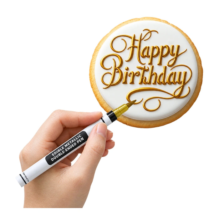 Gold edible metallic pen writing Happy Birthday in script on a white iced cookie
