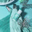 Colour Mill Tiffany bottle on blue-green icing piping bags with butterfly decorations