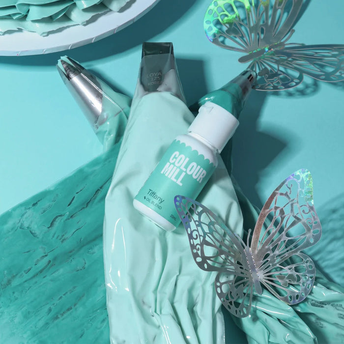 Colour Mill Tiffany bottle on blue-green icing piping bags with butterfly decorations