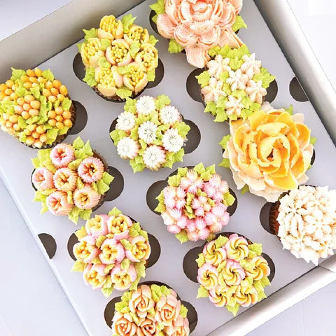 Cupcake decorating inspiration showing assorted floral buttercream designs